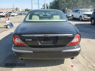 2004 Jaguar XJ with VIN SAJEA71C74SG02851, listed as a Copart auction lot 69056994 with 0 mi miles and Salvage Title. Bid and sale history available at carsss.com. Image 5.