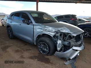 2019 Mazda CX-5 Touring with VIN JM3KFACMXK0670516, listed as a IAAI auction lot 41550274 with 115,018 mi miles. Bid and sale history available at carsss.com. Image 1.
