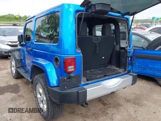 2015 Jeep Wrangler Sahara with VIN 1C4AJWBG9FL663959, listed as a IAAI auction lot 42133900 with 56,253 mi miles and . Bid and sale history available at DreamBid. Image 3.