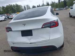 2021 Tesla Model Y Standard Range with VIN 5YJYGDED9MF121828, listed as a IAAI auction lot 42119518 with 34,454 mi miles and . Bid and sale history available at carsss.com. Image 15.