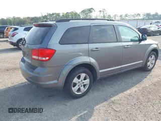 2013 Dodge Journey SE z VIN 3C4PDCAB5DT518019, wystawiony jako IAAI lot #42409340 z przebiegiem 174 339 mil mil oraz . Historia ofert i sprzedaży dostępna na DreamBid. Obrazek 4.