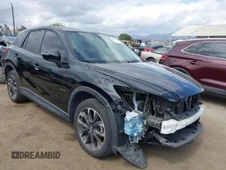 2016 Mazda CX-5 Grand Touring z VIN JM3KE2DY8G0900457, wystawiony jako IAAI lot #42239023 z przebiegiem 92 709 mil mil oraz . Historia ofert i sprzedaży dostępna na DreamBid. Obrazek 1.