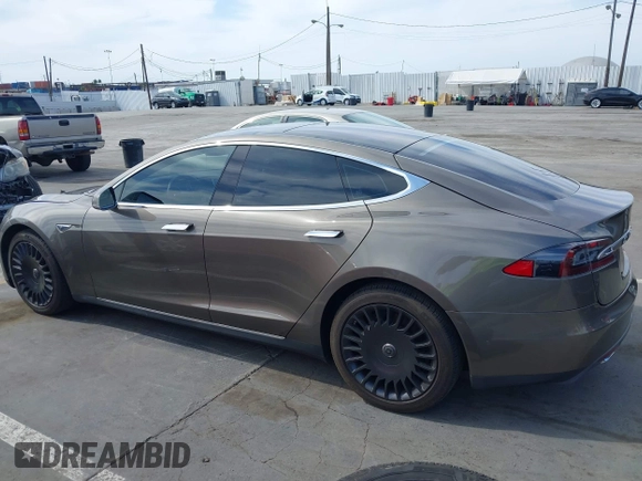 2015 Tesla Model S 85 with VIN 5YJSA1E14FF120455, listed as a IAAI auction lot 42053306 with 62,817 mi miles and . Bid and sale history available at DreamBid. Image 14.