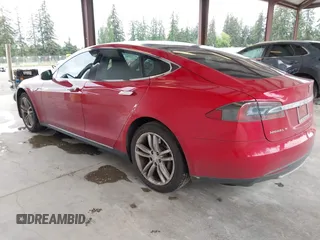 2013 Tesla Model S with VIN 5YJSA1CN7DFP26996, listed as a IAAI auction lot 42244540 with 128,160 mi miles and . Bid and sale history available at DreamBid. Image 3.