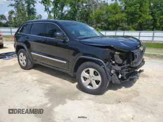 2013 Jeep Grand Cherokee Laredo with VIN 1C4RJEAG2DC519570, listed as a Copart auction lot 52066225 with 129,091 mi miles and Salvage Title. Bid and sale history available at carsss.com. Image 4.