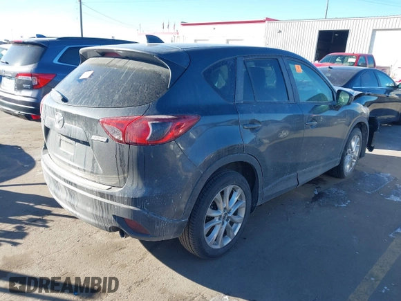 2014 Mazda CX-5 Grand Touring with VIN JM3KE2DY1E0421326, listed as a IAAI auction lot 41330794 with 127,589 mi miles. Bid and sale history available at carsss.com. Image 4.