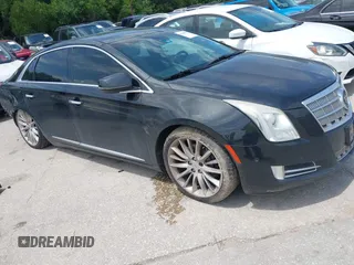 2014 Cadillac XTS Platinum z VIN 2G61S5S34E9241272, wystawiony jako IAAI lot #42343910 z przebiegiem 187 820 mil mil oraz . Historia ofert i sprzedaży dostępna na DreamBid. Obrazek 1.