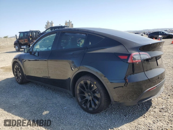 2023 Tesla Model Y Long Range with VIN 7SAYGAEE0PF642810, listed as a Copart auction lot 52181655 with 74,922 mi miles and Salvage Title. Bid and sale history available at DreamBid. Image 2.