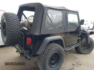2002 Jeep Wrangler Sport with VIN 1J4FA49S02P705470, listed as a IAAI auction lot 42477770 with 59,395 mi miles and . Bid and sale history available at DreamBid. Image 4.