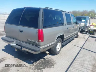 1999 Chevrolet Suburban with VIN 3GNEC16R9XG253081, listed as a IAAI auction lot 41719007 with 196,884 mi miles. Bid and sale history available at carsss.com. Image 4.