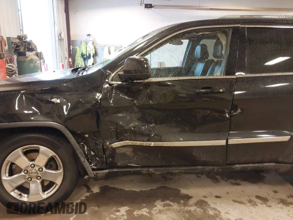 2012 Jeep Grand Cherokee Laredo with VIN 1C4RJFAT1CC225479, listed as a IAAI auction lot 41709911 with 227,150 mi miles. Bid and sale history available at carsss.com. Image 6.