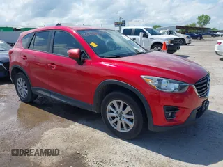 2016 Mazda CX-5 Touring z VIN JM3KE2CY9G0809697, wystawiony jako IAAI lot #42108254 z przebiegiem 99 531 mil mil oraz . Historia ofert i sprzedaży dostępna na DreamBid. Obrazek 1.