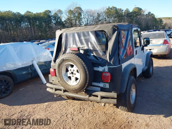 2004 Jeep Wrangler Sport Right Hand Drive with VIN 1J4F449S74P732854, listed as a IAAI auction lot 41408316 with 112,064 mi miles. Bid and sale history available at carsss.com. Image 16.