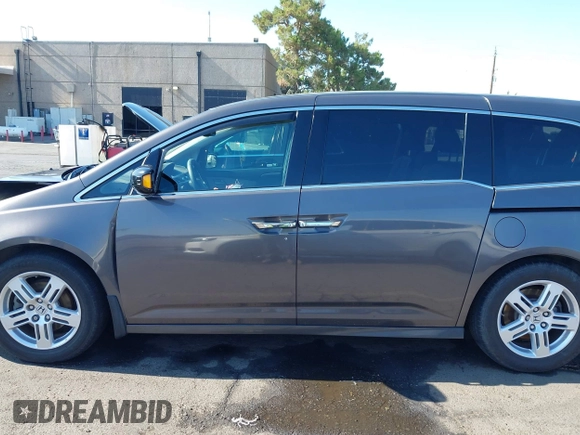 2012 Honda Odyssey Touring with VIN 5FNRL5H95CB057346, listed as a IAAI auction lot 42644094 with 114,712 mi miles and . Bid and sale history available at DreamBid. Image 15.