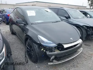 2023 Tesla Model Y Long Range with VIN 7SAYGAEE4PF636427, listed as a IAAI auction lot 42063843 with 16,986 mi miles and . Bid and sale history available at DreamBid. Image 1.
