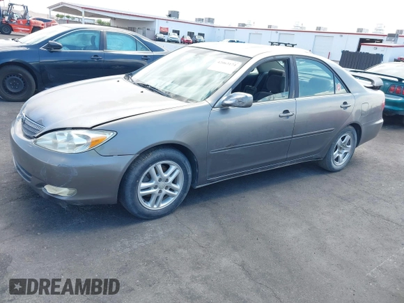 2003 Toyota Camry LE with VIN JTDBE32K130149032, listed as a IAAI auction lot 42063174 with 241,424 mi miles and . Bid and sale history available at DreamBid. Image 2.