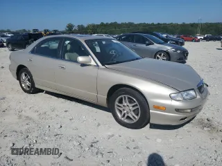 1999 Mazda Millenia z VIN JM1TA2217X1502746, wystawiony jako Copart lot #72165894 z przebiegiem 196 957 mil mil oraz Szkody całkowita. Historia ofert i sprzedaży dostępna na DreamBid. Obrazek 4.