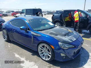 2015 Scion FR-S with VIN JF1ZNAA18F9712580, listed as a IAAI auction lot 42223595 with 157,384 mi miles. Bid and sale history available at carsss.com. Image 1.