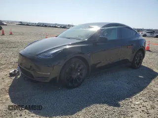 2023 Tesla Model Y Long Range with VIN 7SAYGAEE0PF642810, listed as a Copart auction lot 52181655 with 74,922 mi miles and Salvage Title. Bid and sale history available at DreamBid. Image 1.