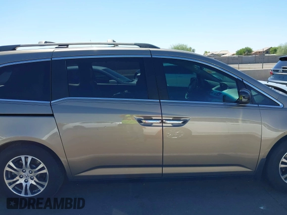 2012 Honda Odyssey EX-L z VIN 5FNRL5H63CB033049, wystawiony jako IAAI lot #42260501 z przebiegiem 165 693 mil mil oraz . Historia ofert i sprzedaży dostępna na DreamBid. Obrazek 14.