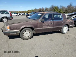 1989 Dodge Dynasty z VIN 1B3BC4637KD532206, wystawiony jako Copart lot #74233744 z przebiegiem 85 245 mil mil oraz Czysty tytuł • Clean title. Historia ofert i sprzedaży dostępna na DreamBid. Obrazek 1.