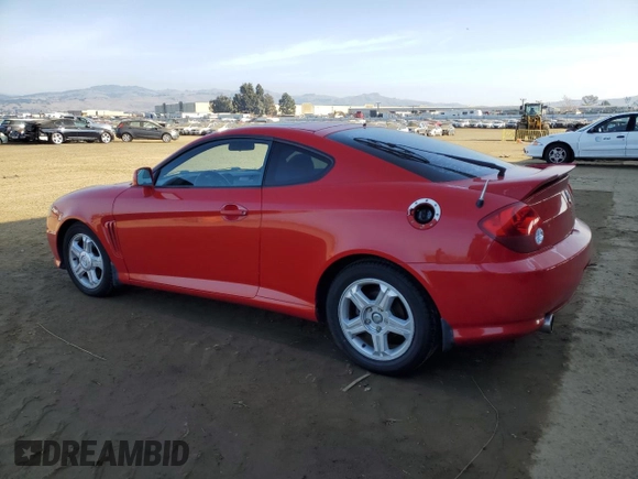 2003 Hyundai Tiburon GT z VIN KMHHN65F63U060104, wystawiony jako Copart lot #84560184 z przebiegiem 160 120 mil mil oraz Czysty tytuł • Clean title. Historia ofert i sprzedaży dostępna na DreamBid. Obrazek 2.