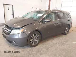 2014 Honda Odyssey Touring with VIN 5FNRL5H99EB105059, listed as a IAAI auction lot 42457672 with 240,581 mi miles and . Bid and sale history available at DreamBid. Image 2.