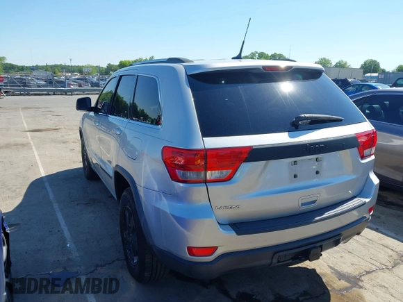 2011 Jeep Grand Cherokee Laredo with VIN 1J4RS4GGXBC513523, listed as a IAAI auction lot 42203802 with 242,239 mi miles and . Bid and sale history available at DreamBid. Image 3.