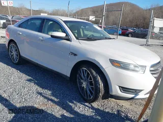 2014 Ford Taurus SEL z VIN 1FAHP2E81EG187116, wystawiony jako IAAI lot #41705418 z przebiegiem 169 664 mil mil oraz . Historia ofert i sprzedaży dostępna na DreamBid. Obrazek 1.
