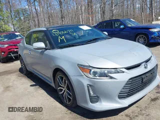2014 Scion tC with VIN JTKJF5C70E3083839, listed as a IAAI auction lot 41886711 with 118,029 mi miles. Bid and sale history available at carsss.com. Image 1.