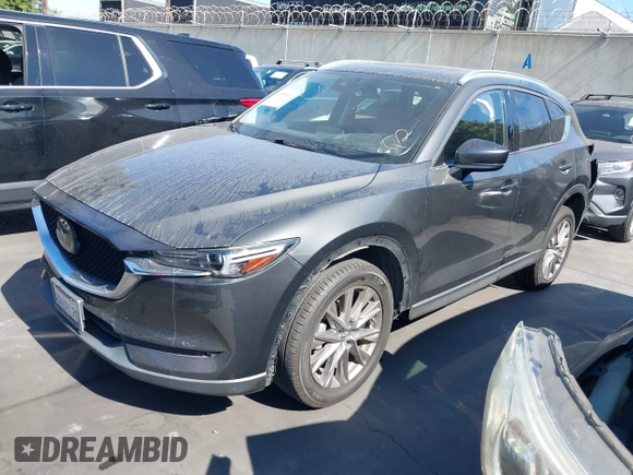 2020 Mazda CX-5 Grand Touring with VIN JM3KFADM3L1812649, listed as a IAAI auction lot 42575393 with 102,118 mi miles and . Bid and sale history available at DreamBid. Image 2.