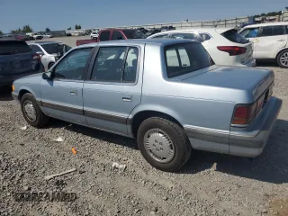 1989 Dodge Spirit z VIN 1B3BA46K1KF408949, wystawiony jako Copart lot #80767594 z przebiegiem 137 766 mil mil oraz Nie do naprawy. Historia ofert i sprzedaży dostępna na DreamBid. Obrazek 2.