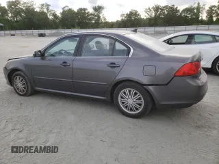 2009 Kia Optima LX z VIN KNAGE228695331919, wystawiony jako Copart lot #57804835 z przebiegiem 199 204 mil mil oraz Szkoda całkowita • Salvage title. Historia ofert i sprzedaży dostępna na DreamBid. Obrazek 2.