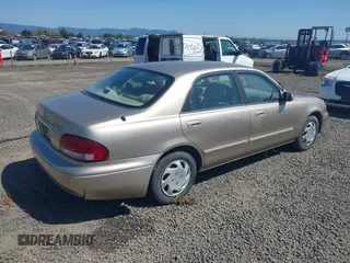 1999 Mazda 626 ES z VIN 1YVGF22C5X5811946, wystawiony jako IAAI lot #41970165 z przebiegiem 126 709 mil mil oraz . Historia ofert i sprzedaży dostępna na DreamBid. Obrazek 4.