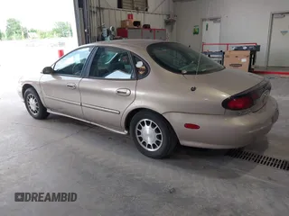 1999 Ford Taurus SE Comfort z VIN 1FAFP53S0XG145837, wystawiony jako IAAI lot #42384370 z przebiegiem 94 870 mil mil oraz . Historia ofert i sprzedaży dostępna na DreamBid. Obrazek 3.
