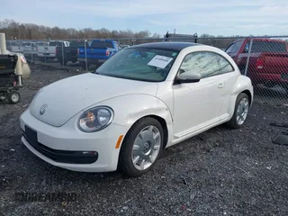 2014 Volkswagen Beetle 2.5L w/Sun with VIN 3VWJP7AT8EM611560, listed as a IAAI auction lot 41488488 with 140,798 mi miles and . Bid and sale history available at DreamBid. Image 2.