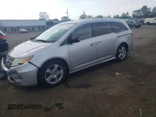 2011 Honda Odyssey Touring with VIN 5FNRL5H9XBB104482, listed as a Copart auction lot 62233255 with 199,996 mi miles and Salvage title. Bid and sale history available at DreamBid. Image 1.