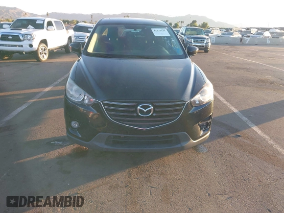 2016 Mazda CX-5 Touring with VIN JM3KE2CY5G0704574, listed as a IAAI auction lot 41033546 with 133,502 mi miles. Bid and sale history available at carsss.com. Image 6.