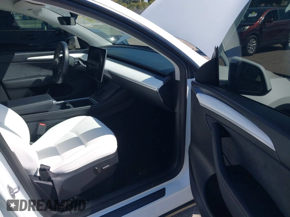 2024 Tesla Model Y with VIN 7SAYGDED9RF161420, listed as a IAAI auction lot 41892788 with 12,353 mi miles and . Bid and sale history available at DreamBid. Image 5.