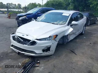 2020 Ford Fusion SE z VIN 3FA6P0LU5LR153942, wystawiony jako IAAI lot #42145638 z przebiegiem 99 961 mil mil oraz . Historia ofert i sprzedaży dostępna na DreamBid. Obrazek 2.
