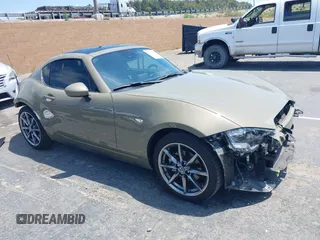 2023 Mazda MX-5 Miata Grand Touring z VIN JM1NDAM73P0561844, wystawiony jako IAAI lot #42195198 z przebiegiem 6 020 mil mil oraz . Historia ofert i sprzedaży dostępna na DreamBid. Obrazek 1.