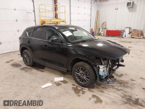 2021 Mazda CX-5 Touring with VIN JM3KFBCM1M1380409, listed as a IAAI auction lot 41677537 with 55,319 mi miles. Bid and sale history available at carsss.com. Image 1.