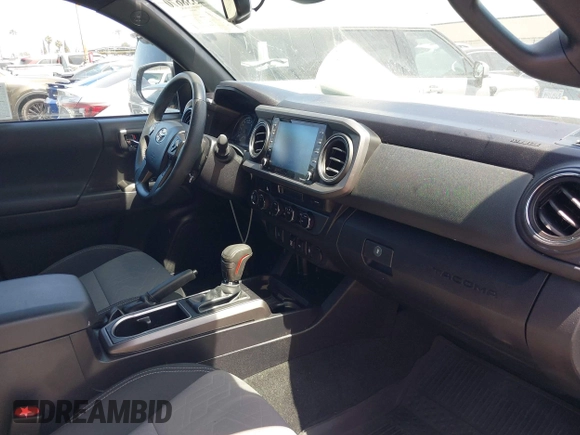 2023 Toyota Tacoma SR with VIN 3TMCZ5AN3PM590101, listed as a IAAI auction lot 42338670 with 12,970 mi miles and . Bid and sale history available at DreamBid. Image 5.