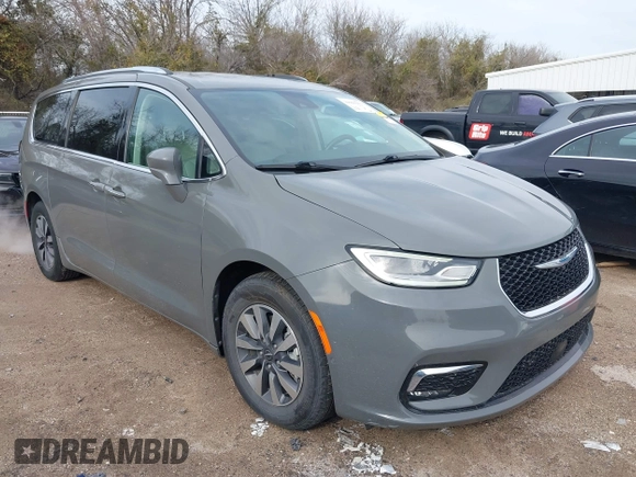 2021 Chrysler Pacifica Hybrid Touring L z VIN 2C4RC1L78MR596371, wystawiony jako IAAI lot #39993913 z przebiegiem 64 830 mil mil oraz . Historia ofert i sprzedaży dostępna na DreamBid. Obrazek 1.