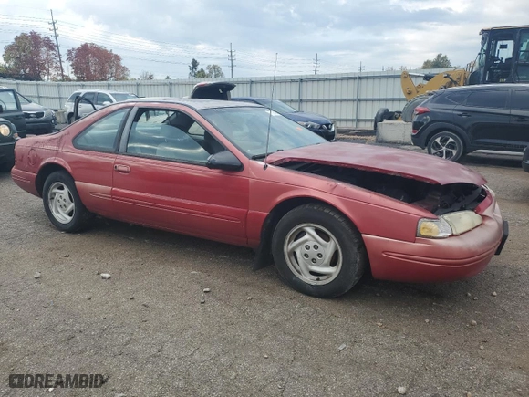 1996 Ford Thunderbird LX with VIN 1FALP62W7TH135632, listed as a Copart auction lot 77134024 with 128,931 mi miles and Salvage Title. Bid and sale history available at carsss.com. Image 4.