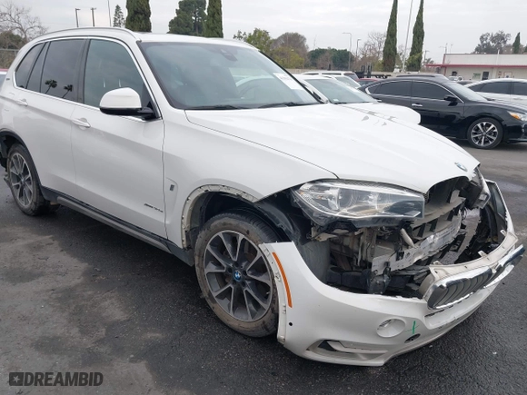 2018 BMW X5 xDrive40e iPerformance with VIN 5UXKT0C58J0V99415, listed as a IAAI auction lot 41391474 with 124,671 mi miles. Bid and sale history available at carsss.com. Image 1.