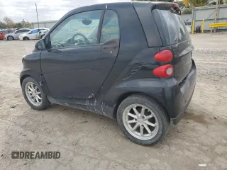 2009 Smart fortwo Pure with VIN WMEEJ31X19K267800, listed as a Copart auction lot 77392744 with 100,178 mi miles and Salvage Title. Bid and sale history available at carsss.com. Image 2.