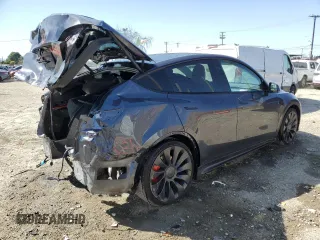 2023 Tesla Model Y Performance with VIN 7SAYGDEF0PF915030, listed as a Copart auction lot 50159375 with 19,772 mi miles and Salvage Title. Bid and sale history available at DreamBid. Image 3.