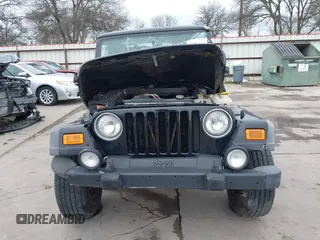 2004 Jeep Wrangler Sport with VIN 1J4FA49S64P794559, listed as a IAAI auction lot 41644201 with 107,445 mi miles. Bid and sale history available at carsss.com. Image 6.