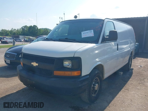 2014 Chevrolet Express Cargo Van with VIN 1GCWGFCG0E1100859, listed as a IAAI auction lot 42142748 with 182,900 mi miles. Bid and sale history available at carsss.com. Image 2.